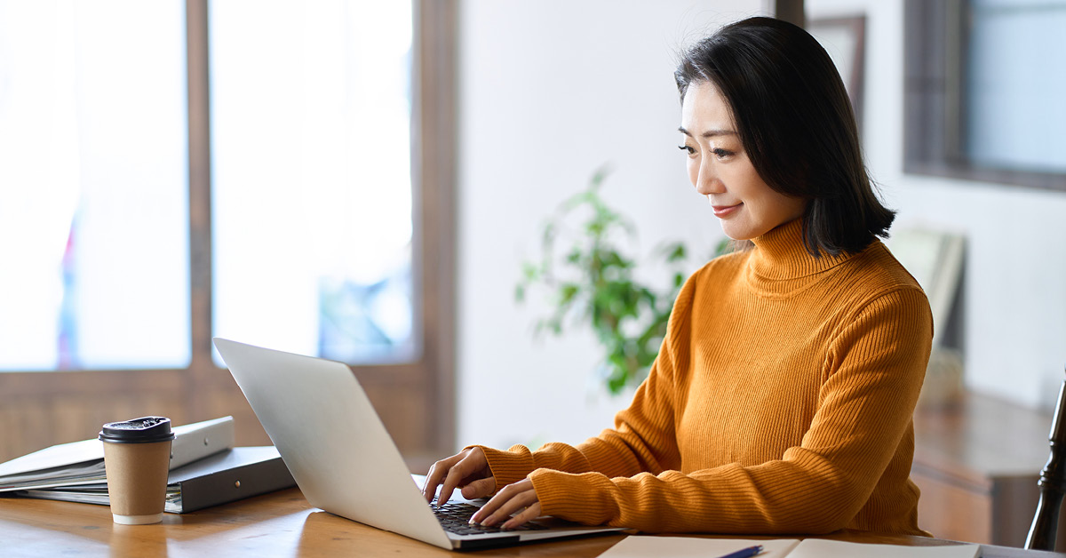 Woman types on a laptop in her office