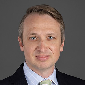 Professional headshot of Andrew Alexander