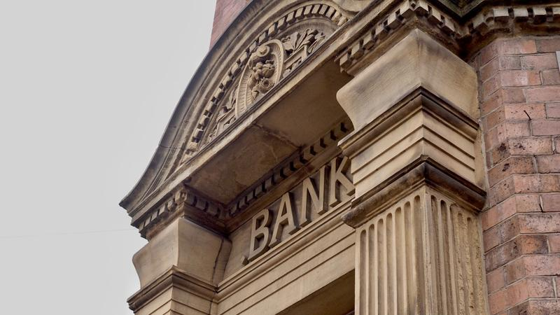 A historic building showcases intricate architectural details, featuring columns, balconies, and a timeless city charm.