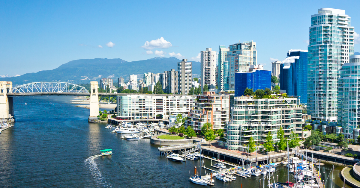 The cityscape, adorned with architectural marvels, reflects beautifully on the water under the clear blue sky.