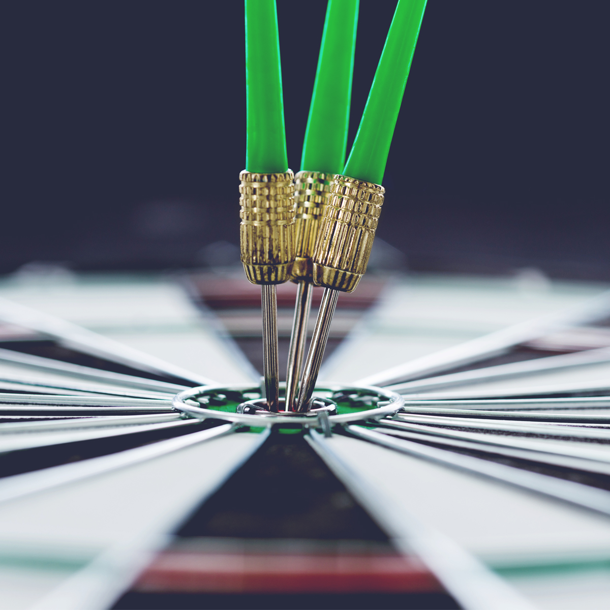 Square business photo depicting marketing goals, competitive darts, javelin themes, stock metrics, and trident-like spokes.
