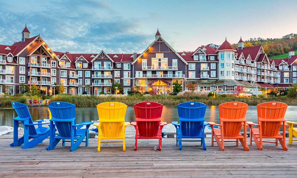 Professional real estate photo of a waterfront neighbourhood, showing a deck with community landscape in a resort town.