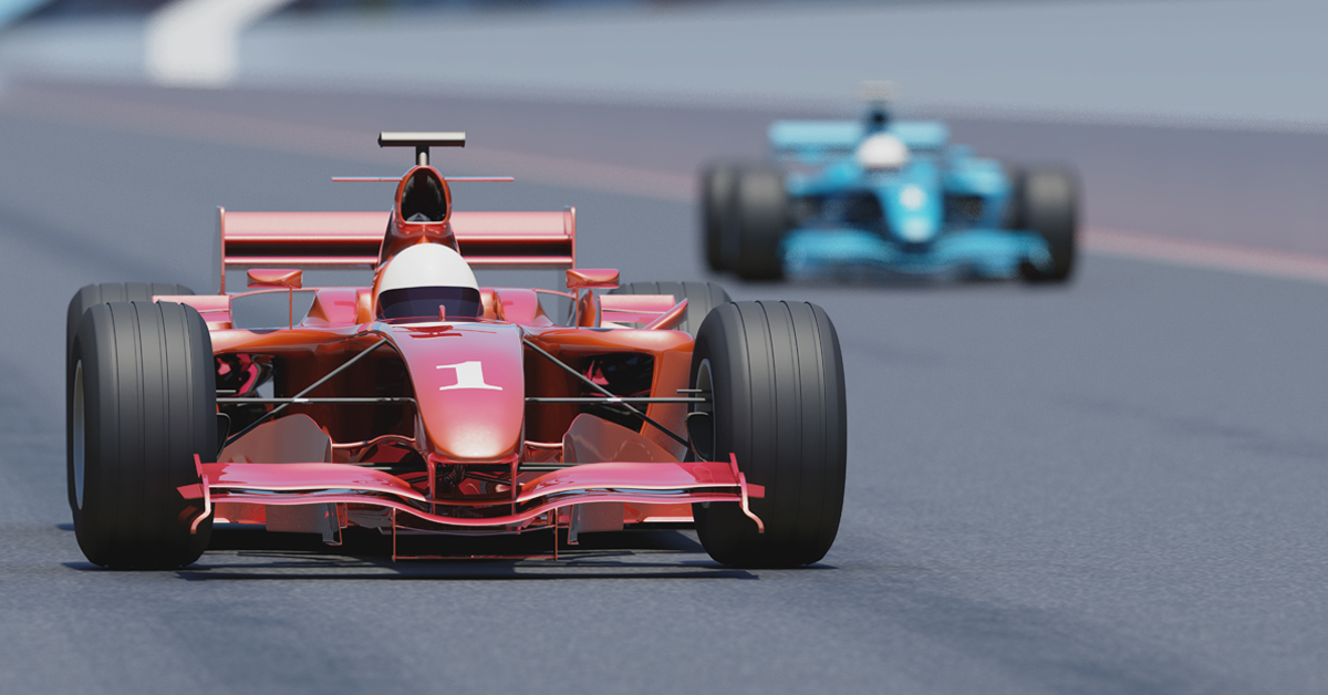 racecars zooming on speedway track