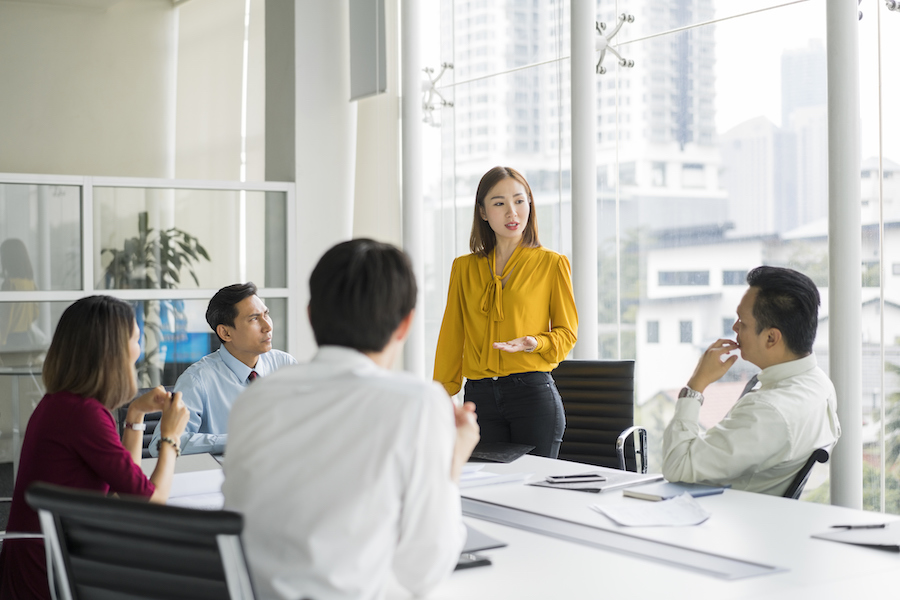 A team of dedicated businesspeople engaging in a crucial corporate meeting, fostering open communication in the office.