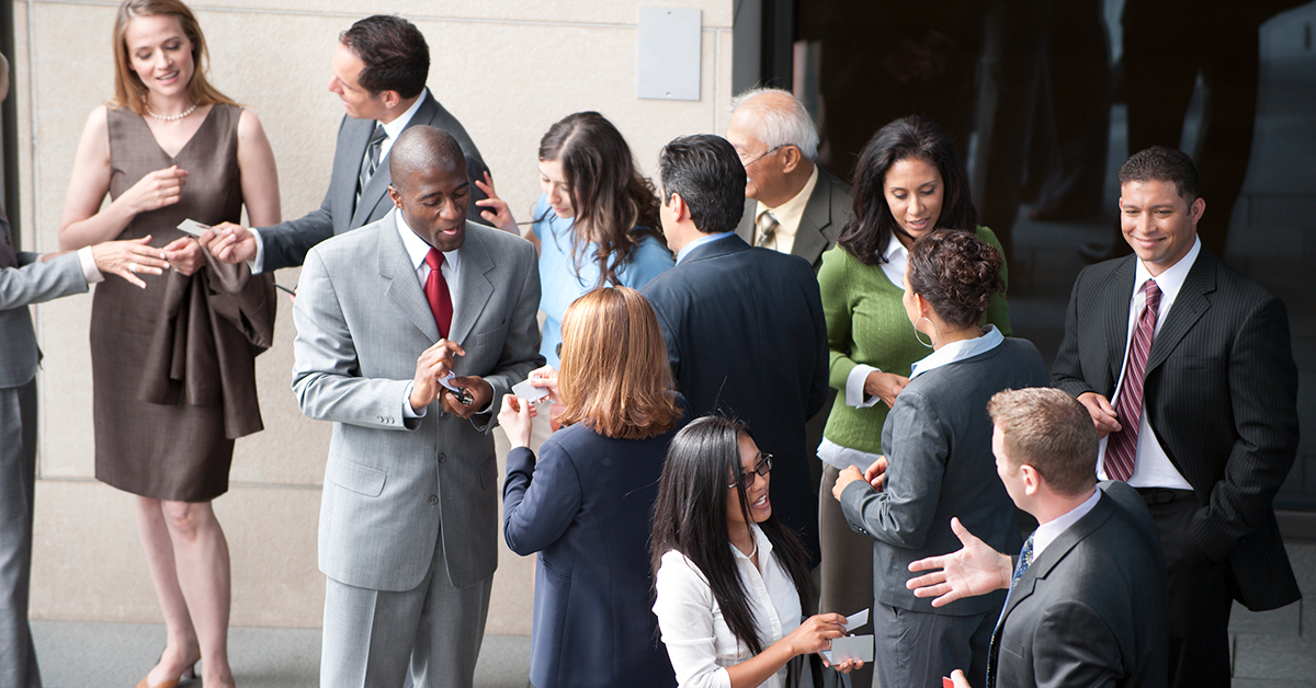 A diverse group of professional businesspeople collaboratively strategizing in a corporate office environment.