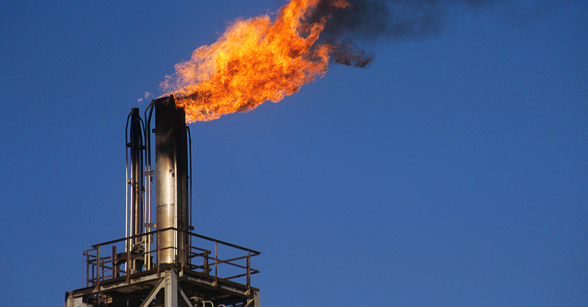 Industrial factories emit smoke from chimneys, contributing to air pollution, in the quest for energy production.