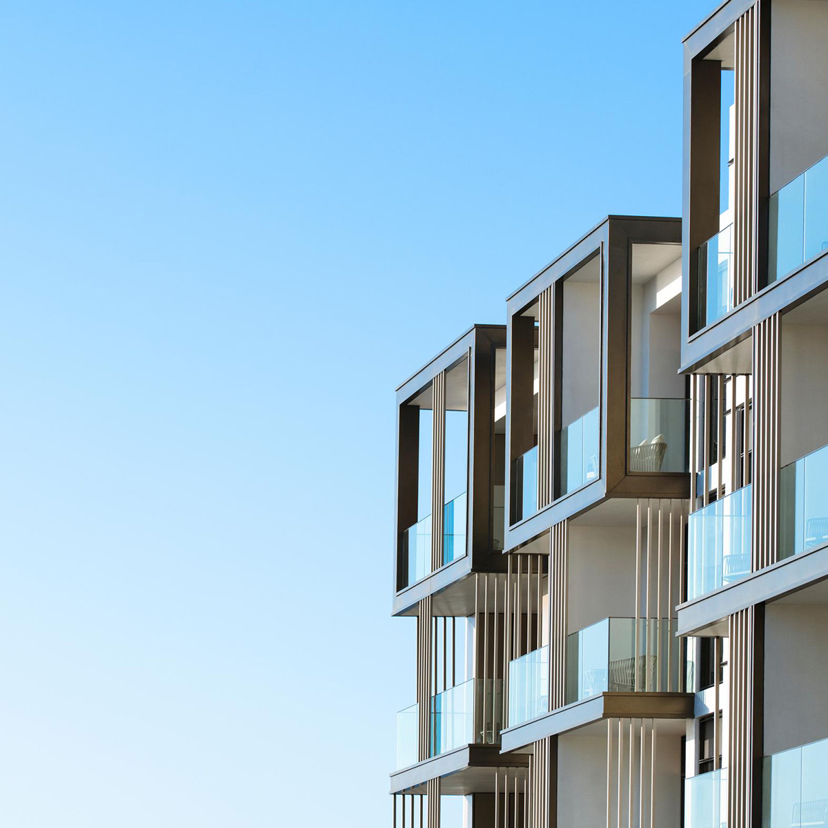 Immerse yourself in the blend of contemporary design showcased by this blue apartment complex, providing urban vistas from every aperture.