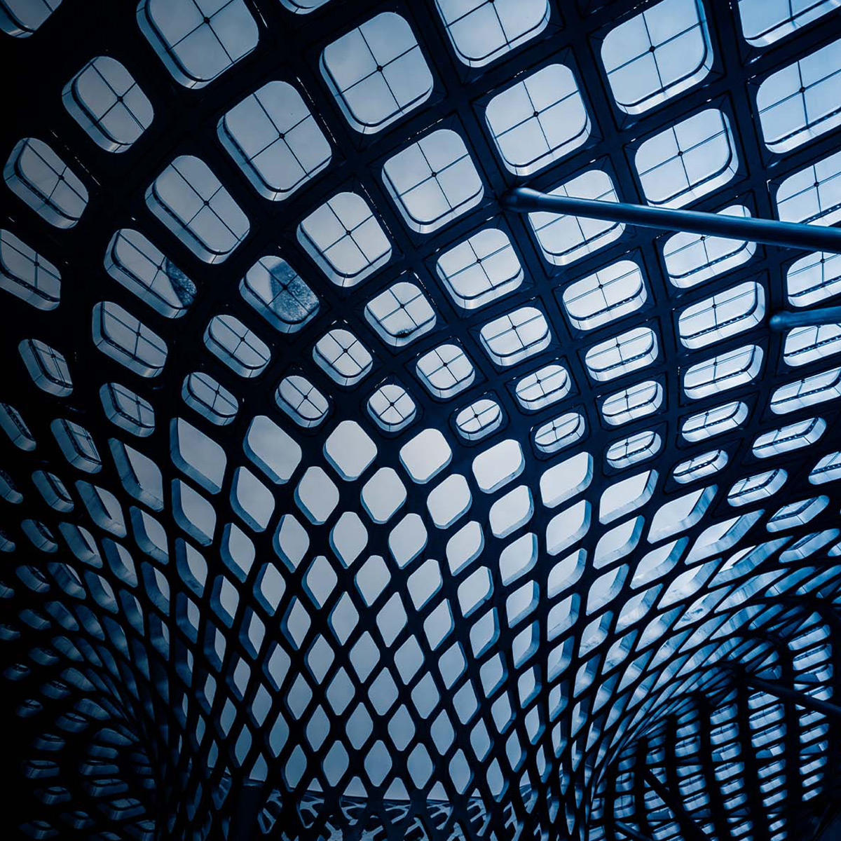 This graphic depicts a fusion of architectural elements and design, highlighted by a backdrop of blue square glass textures.