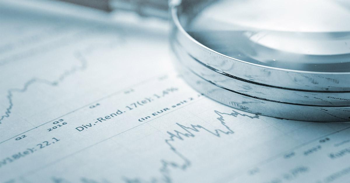 A financial concept book, glasses, and a dictionary are essential tools for business education and understanding finance texts.