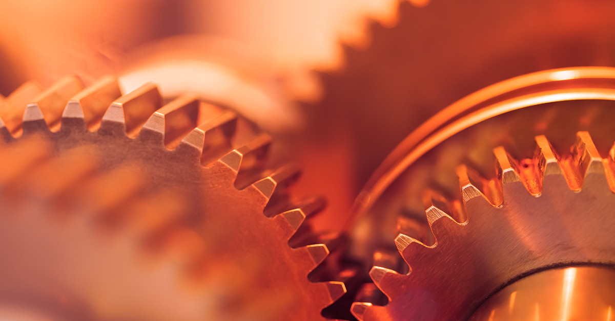 Abstract industrial scene with a metallic hub gear and rotor, illustrating rotary gearbox components in manufacturing.