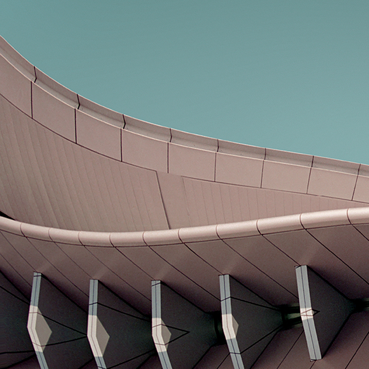 Architectural photo of a square rooftop with crescent forms and a fin-like awning, echoing naval architecture.