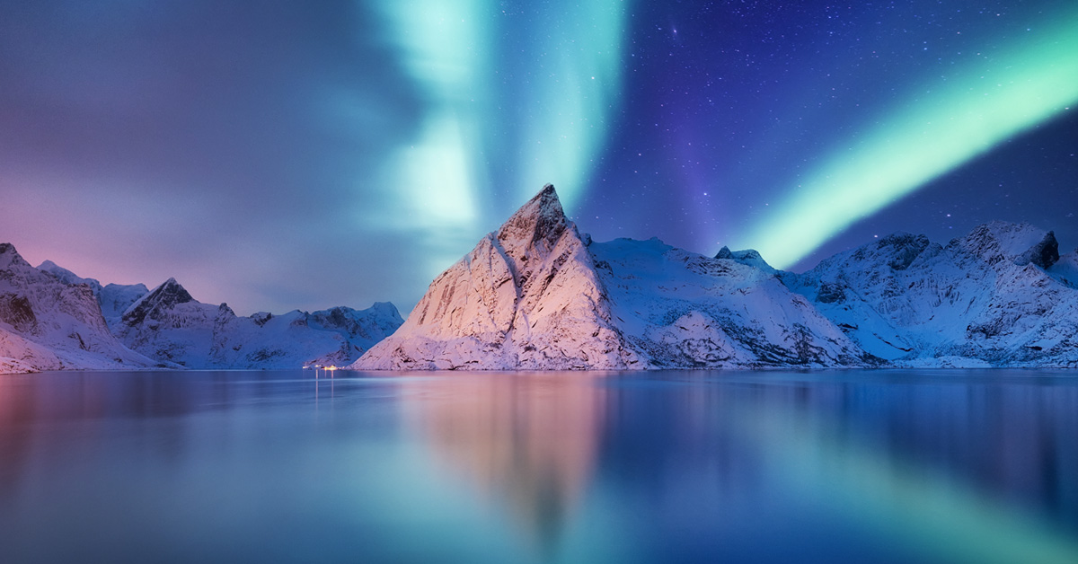 An icy, blue landscape where sea meets sky, showcasing the stunning beauty of snow-covered mountains in nature.