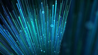 Abstract blue background featuring digital fiber optic light patterns, symbolizing modern technology and internet connectivity.