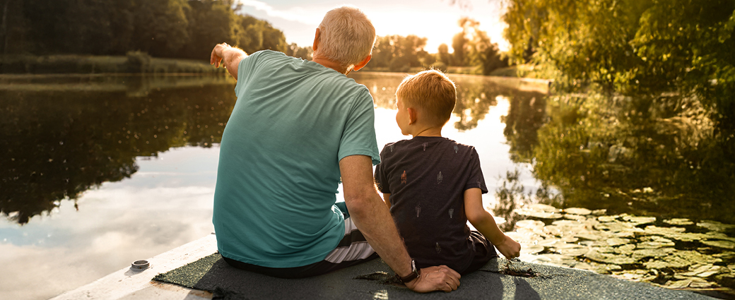 A happy couple smiles warmly with their child, embodying love and togetherness in a joyful family moment.